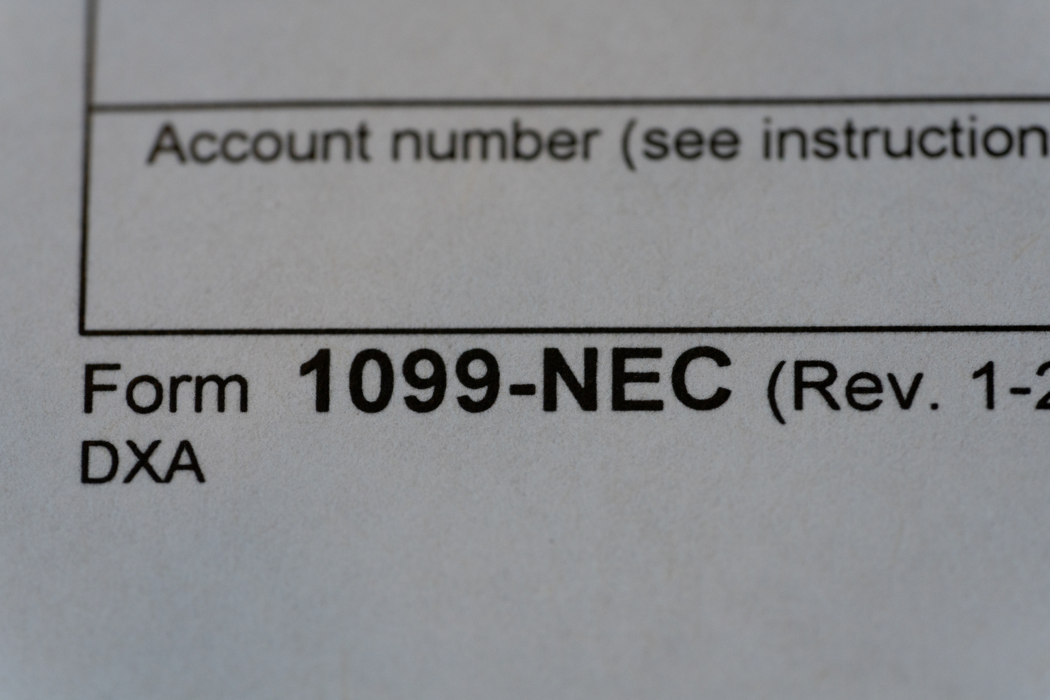 Freelancer reviewing 1099 tax documents and calculating how much to set aside for taxes